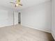 A standard bedroom with neutral carpet, a ceiling fan, and a view to another room at 3920 Cain Mill Dr, Lithonia, GA 30038