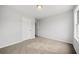 A standard bedroom with neutral carpet, and a view to another room at 3920 Cain Mill Dr, Lithonia, GA 30038