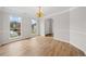 Bright dining room featuring hardwood floors, a chandelier, and natural light at 3920 Cain Mill Dr, Lithonia, GA 30038