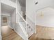 Bright entryway featuring a staircase with carpeted steps and hardwood flooring at 3920 Cain Mill Dr, Lithonia, GA 30038