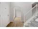 Entryway showcasing hardwood floors and a staircase with white railing at 3920 Cain Mill Dr, Lithonia, GA 30038