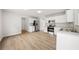Bright open kitchen with stainless steel appliances, white cabinets, and wood-look floors at 3920 Cain Mill Dr, Lithonia, GA 30038