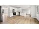 Open kitchen with stainless steel appliances, modern fixtures, and wood-look flooring at 3920 Cain Mill Dr, Lithonia, GA 30038