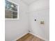 Well-lit laundry room with wire shelving and window, offering convenience and practicality at 3920 Cain Mill Dr, Lithonia, GA 30038