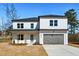 Charming two-story home featuring a white brick exterior, modern design, and a gray two-car garage at 482 Majestic Oaks Pl, Smyrna, GA 30082