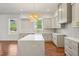 Bright kitchen boasts an island with a white countertop, stainless steel appliances, and light gray cabinetry at 482 Majestic Oaks Pl, Smyrna, GA 30082