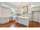 Stylish kitchen features a center island, light gray cabinetry, geometric backsplash, and pendant lighting at 482 Majestic Oaks Pl, Smyrna, GA 30082