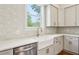 Modern kitchen features white cabinets, white countertops, gold faucet, and patterned tile backsplash at 482 Majestic Oaks Pl, Smyrna, GA 30082