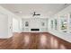 Spacious living room with hardwood floors, modern ceiling fan, recessed lights, and large windows for ample natural light at 482 Majestic Oaks Pl, Smyrna, GA 30082