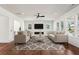 Spacious and modern living room featuring hardwood floors, recessed lighting, and large windows at 482 Majestic Oaks Pl, Smyrna, GA 30082