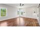 Large primary bedroom with wood floors, modern trim, and large windows overlooking trees at 482 Majestic Oaks Pl, Smyrna, GA 30082