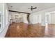 Sun-drenched open concept living space with hardwood floors connecting the kitchen, living room, and staircase at 482 Majestic Oaks Pl, Smyrna, GA 30082