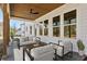 Cozy outdoor living space on a covered patio, featuring comfortable seating and serene surroundings at 482 Majestic Oaks Pl, Smyrna, GA 30082