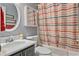Bathroom with shower and tub featuring striped curtain, gray walls and black vanity at 633 Windy Mill Xing, Temple, GA 30179