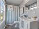 Bright bathroom with vanity, toilet, and shower with light blue curtain and white towels at 633 Windy Mill Xing, Temple, GA 30179