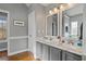 Bright bathroom with double vanity, marble countertops, and neutral gray paint at 633 Windy Mill Xing, Temple, GA 30179