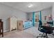 Bedroom with large rug, full sized bed, work desk, and view from the window at 633 Windy Mill Xing, Temple, GA 30179
