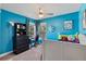Blue bedroom with a single bed, black dresser and desk area with natural light at 633 Windy Mill Xing, Temple, GA 30179