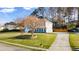 Two-story home showcasing a well-manicured lawn, long driveway and a three-car garage at 633 Windy Mill Xing, Temple, GA 30179