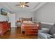 Spacious main bedroom with tray ceiling, dark wood furniture and seating area at 633 Windy Mill Xing, Temple, GA 30179