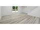 Open finished basement with vinyl floors, white walls, and walkout to deck at 6337 Lake View Dr, Buford, GA 30518