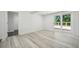 Finished basement with vinyl floors, white walls, and sliding glass door to deck at 6337 Lake View Dr, Buford, GA 30518