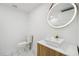 Modern bathroom features a vessel sink, round mirror with lighting, and marble flooring at 6337 Lake View Dr, Buford, GA 30518