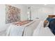 Bedroom featuring bed with a decorative quilt and eye-catching modern art on the wall at 6337 Lake View Dr, Buford, GA 30518