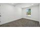 Bedroom featuring a carpeted floor, a window, and crisp white walls at 6337 Lake View Dr, Buford, GA 30518