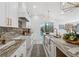 Bright kitchen featuring granite countertops, farmhouse sink, and modern chandelier overlooking lake view at 6337 Lake View Dr, Buford, GA 30518