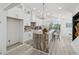 Bright, modern kitchen with granite countertops, white cabinetry, and modern lighting fixtures at 6337 Lake View Dr, Buford, GA 30518