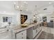 Spacious kitchen with large island, stainless steel sink, pendant lighting, and breakfast nook at 6337 Lake View Dr, Buford, GA 30518