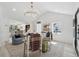 Bright living room featuring vaulted ceiling, modern chandelier, and beautiful decor at 6337 Lake View Dr, Buford, GA 30518