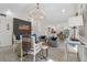 Open-concept living room with modern lighting, stylish furnishings, and easy access to the kitchen at 6337 Lake View Dr, Buford, GA 30518