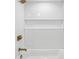 All-white tiled shower and gold fixtures at 6337 Lake View Dr, Buford, GA 30518