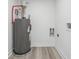 Utility room with water heater and new flooring at 6337 Lake View Dr, Buford, GA 30518