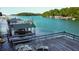 Lakefront dock featuring a covered boat slip, lounging area, and a scenic view at 6337 Lake View Dr, Buford, GA 30518