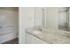 Modern bathroom with granite countertops, white cabinetry, and a large mirror over the sink at 7004 Panda Ln, Austell, GA 30168