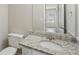 Bathroom features granite countertops, white cabinets, and a large mirror at 7004 Panda Ln, Austell, GA 30168