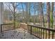 A wooden deck surrounded by lush trees, perfect for enjoying the peaceful and natural outdoor environment at 7004 Panda Ln, Austell, GA 30168