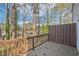 View from a cozy deck overlooking a private backyard with trees, creating a tranquil retreat at 7004 Panda Ln, Austell, GA 30168