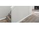 Hallway with luxury vinyl flooring and staircase with carpeted steps and white risers at 7004 Panda Ln, Austell, GA 30168