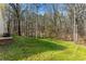 Expansive backyard featuring lush green grass surrounded by mature trees, creating a private, natural setting at 2374 Buchanan Hwy, Dallas, GA 30157