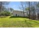 Exterior shot featuring a well-maintained backyard with lush greenery and trees and home at 2374 Buchanan Hwy, Dallas, GA 30157