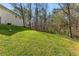 Spacious green backyard with mature trees in a tranquil setting next to the back of the house at 2374 Buchanan Hwy, Dallas, GA 30157
