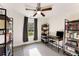 An office/bedroom boasts ample natural light, built-in bookshelves and sleek flooring at 2374 Buchanan Hwy, Dallas, GA 30157
