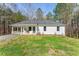 Charming, single-story white home with a welcoming front yard and a convenient carport at 2374 Buchanan Hwy, Dallas, GA 30157