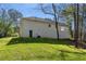 Back exterior view of home with a white brick facade, covered patio, and a door leading to the backyard at 2374 Buchanan Hwy, Dallas, GA 30157