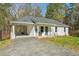 Charming, single-story white home with a welcoming front yard and a convenient carport at 2374 Buchanan Hwy, Dallas, GA 30157