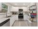 The bright kitchen includes stainless appliances, granite countertops and generous pantry space at 2374 Buchanan Hwy, Dallas, GA 30157